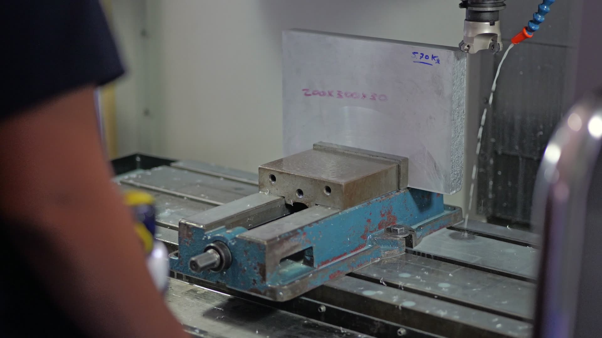 Steel part clamped in a CNC mill — real MIKRO-PRO workshop.